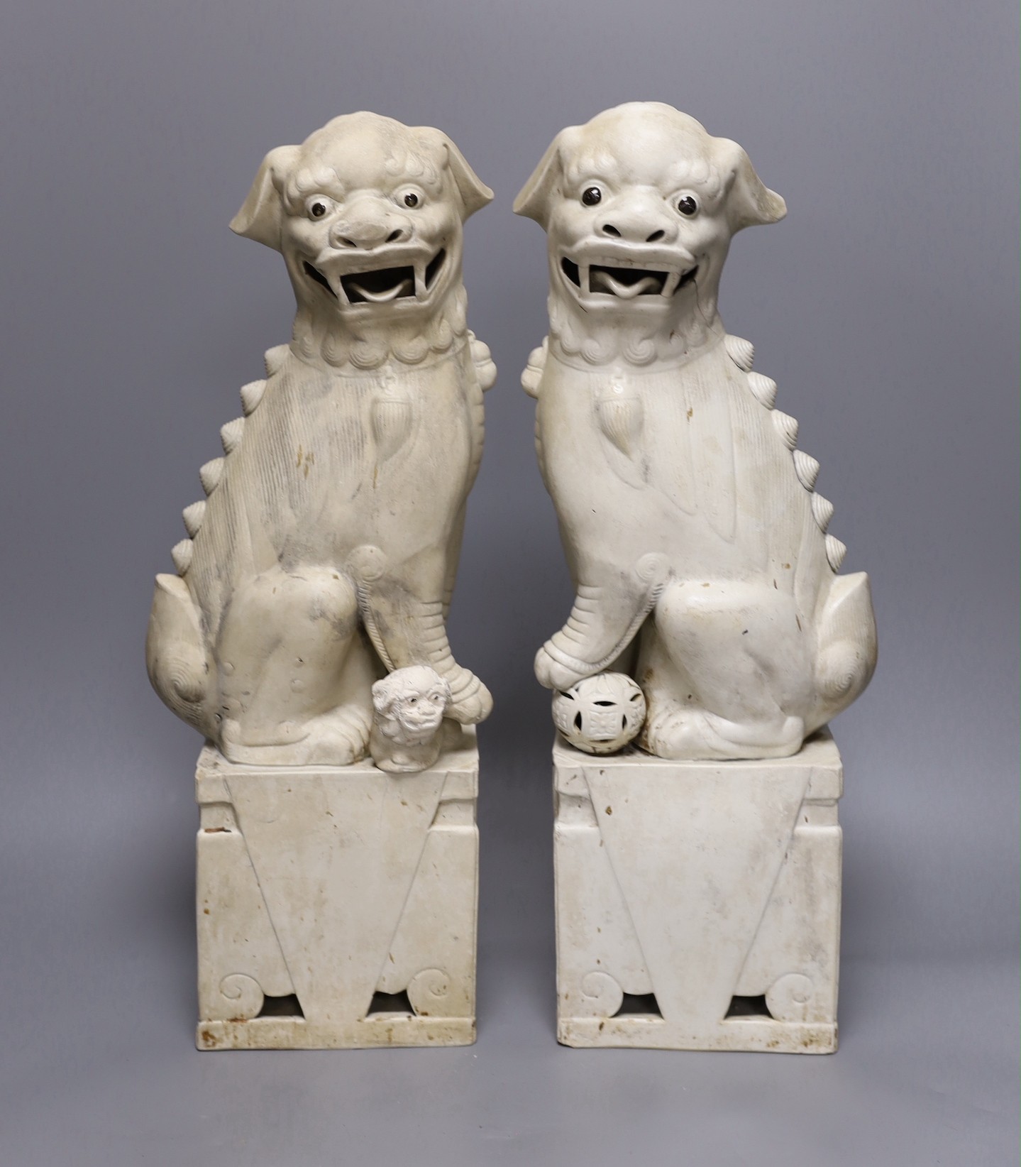 A pair of large Chinese biscuit porcelain lion-dog figures, 45cms high
